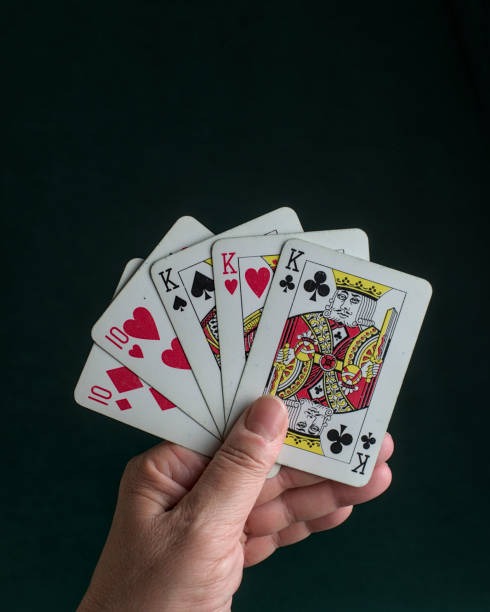 Dealer rolling three dice in transparent cup